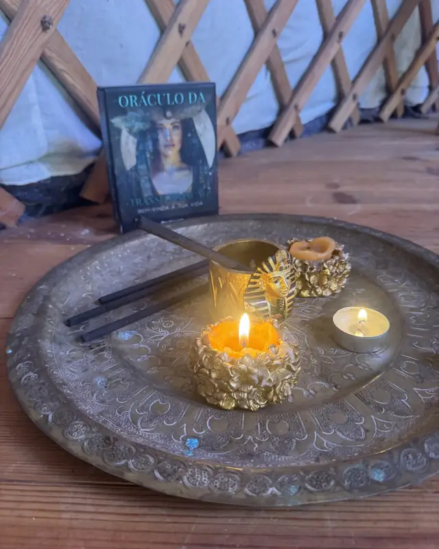 Altar with lit candles, incense and the Oracle of Transformation on a brass tray